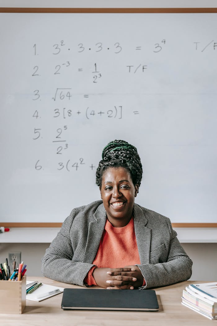 Happy African American female smiling and looking at camera after lesson on classroom
